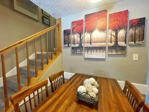 una sala da pranzo con tavolo e alcuni dipinti alle pareti di Valley Condo 106 - Creekside - WiFi - Hot Tub - Fireplace - Washer - Dryer - Playground a Red River