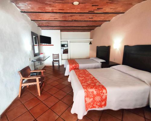 Ένα ή περισσότερα κρεβάτια σε δωμάτιο στο Hotel El Pescador