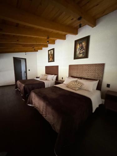a room with three beds in a room at Cabaña Colorata Residencial in Atemajac de Brizuela