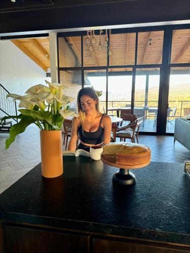 a woman sitting at a counter in a room at Cabaña Colorata Residencial in Atemajac de Brizuela