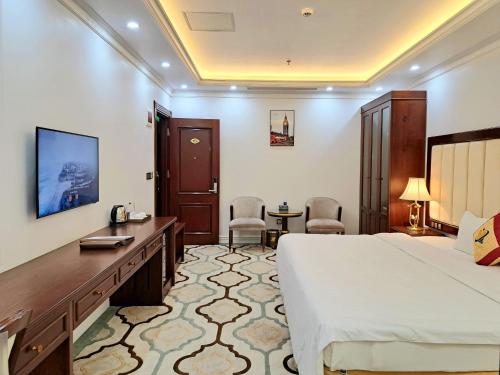 a hotel room with a bed and a desk at THE SHINE 2 HOTEL & APARTMENT in Ðông Khê