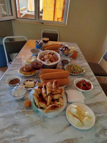 a table with many plates of food on it at Hоuse Baatyr78 in Barskoon