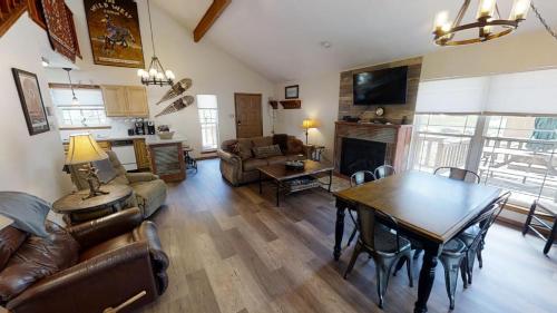 a living room with a table and a dining room at Whispering Pines - On the River - Great Views - Satellite - WiFi - Great Outdoor Deck! in Red River