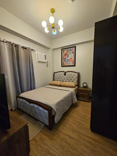 a bedroom with a bed and a ceiling fan at Verdon Parc 2 Bedroom Unit with Big Balcony in Davao City