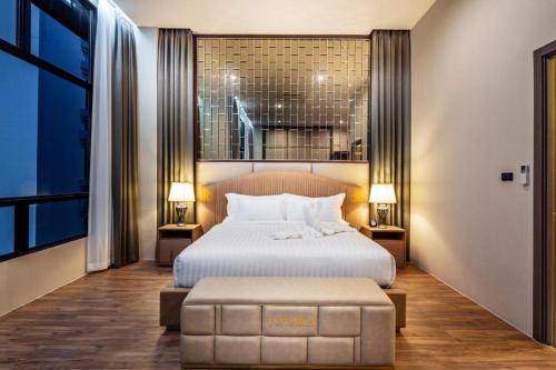 a bedroom with a large bed and a large window at The Grand Sala Thai in Bangkok