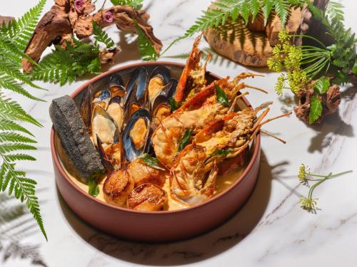 a bowl of shrimp and mussels on a table at Pullman Singapore Orchard in Singapore