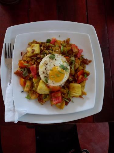 a plate of food with an egg on top at Sand Dune Beach Resort & Surf Camp in Arugam Bay