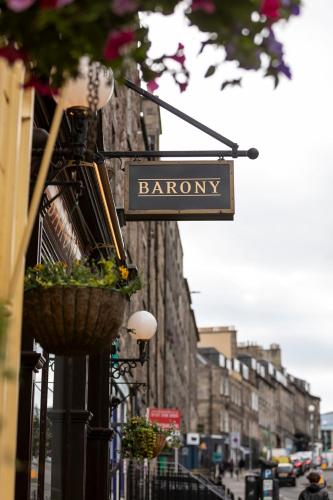 a sign for a barony hanging on a city street at The Broughton Townhouse in Edinburgh