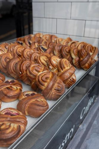 a display case filled with lots of different types of pastries at The Broughton Townhouse in Edinburgh