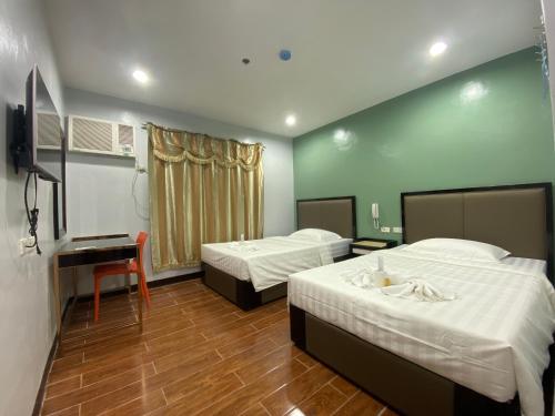 Postel nebo postele na pokoji v ubytování Asia Jem Hotel - BAYAWAN