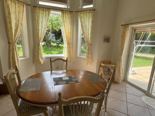 a dining room with a wooden table and chairs at Beachfront Paradise Ishigaki in Ishigaki Island