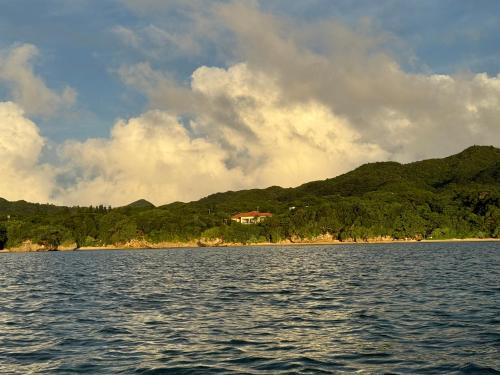 a house on the shore of a body of water at Beachfront Paradise Ishigaki in Ishigaki Island
