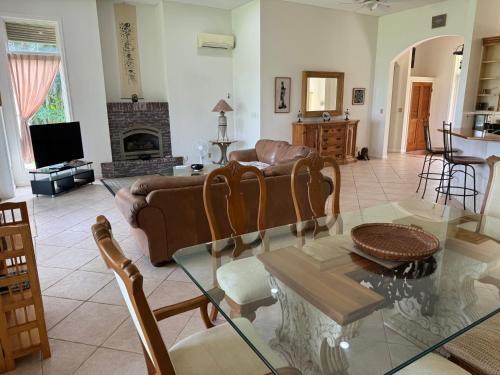 a living room with a couch and a table at Beachfront Paradise Ishigaki in Ishigaki Island