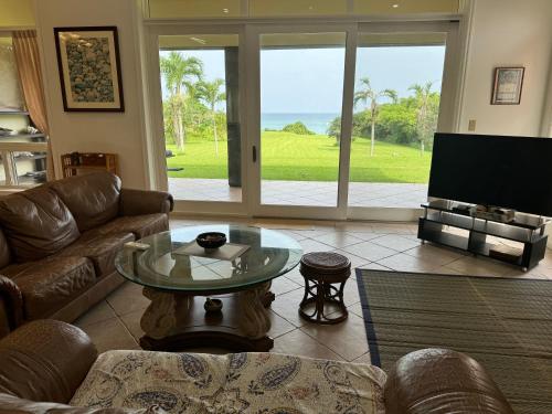 a living room with a couch and a table at Beachfront Paradise Ishigaki in Ishigaki Island