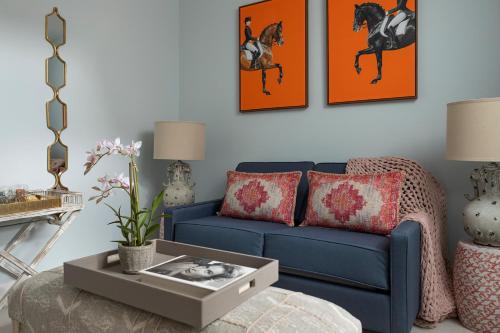 a living room with a blue couch and a table at The Broughton Townhouse in Edinburgh