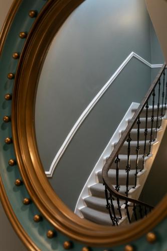 a reflection of a staircase in a mirror at The Broughton Townhouse in Edinburgh