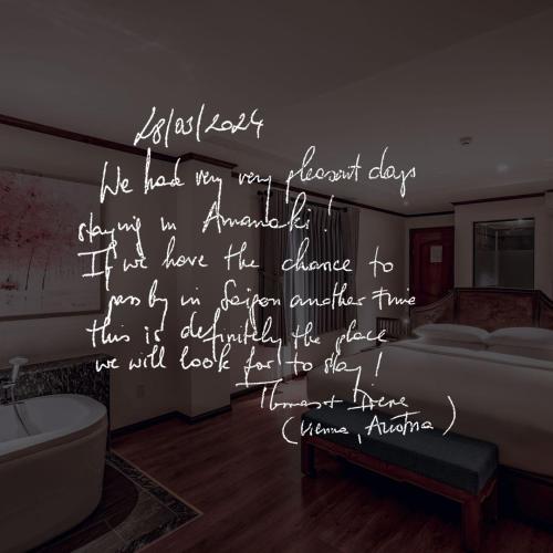 a room with a bed with writing on the wall at Amanaki Saigon Boutique Hotel in Ho Chi Minh City