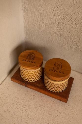 two wooden baskets sitting on a wooden shelf at SIVANA, Hotel Boutique with ocean or garden views - Adults only in Uluwatu