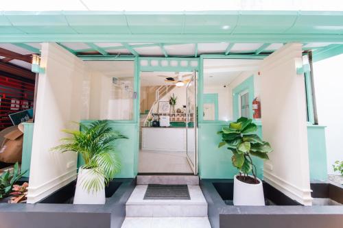 a hallway with potted plants in a building at Catnip Seaside Hotel&Cafe in Ban Huai Luk (1)