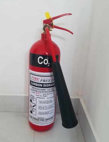 a fire extinguisher next to a bottle of fire brigadeacistacist at Gert's Aerovista villa in Seeduwa