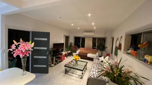 a living room with a couch and a table at Tranquil Garden view Room Macquiare Marsfield Eastwood in Sydney