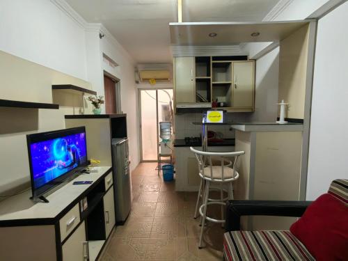 a small apartment with a kitchen and a living room at Cibubur Village By Arsakha Property Management in Cibubur