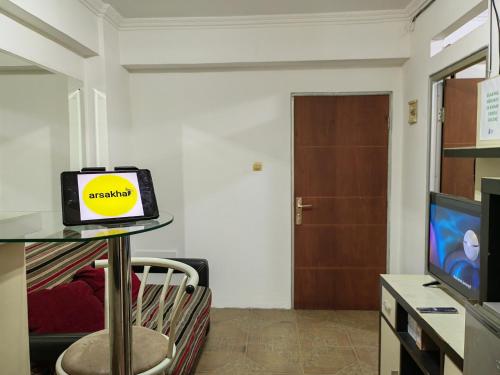 a living room with a table with a clock on it at Cibubur Village By Arsakha Property Management in Cibubur