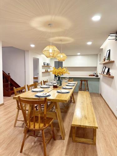 a kitchen and dining room with a wooden table and chairs at Bunya House near BTS Asok, Terminal21 Free BF in Bangkok