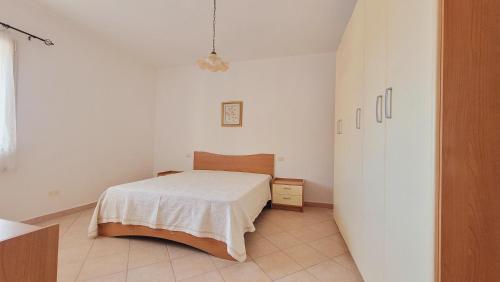 Ένα ή περισσότερα κρεβάτια σε δωμάτιο στο Residenza La Pineta Orosei