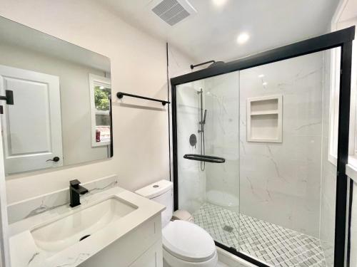 a bathroom with a shower and a sink and a toilet at New 3 Bedroom Bungalow Ground Floor with BBQ Patio in Richmond Hill