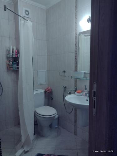 a bathroom with a toilet and a sink at Messembria Palace Bulgaria in Sunny Beach
