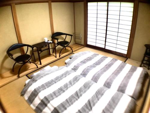 Postel nebo postele na pokoji v ubytování Yunonouchi ゆののうち