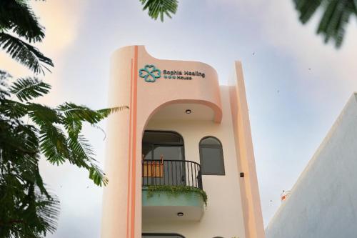 a building with a balcony on the side of it at Sophia Healing House Cần Thơ in Can Tho
