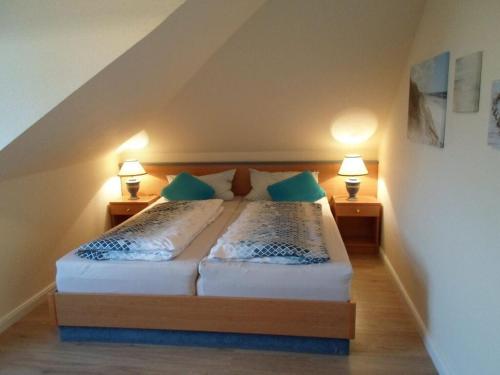 a bedroom with a bed with two lamps on both sides at Flotsam and jetsam Modern retreat in Kühlungsborn