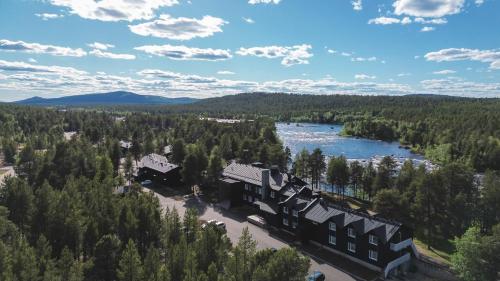 an aerial view of a resort with a river and trees at Wilderness Hotel Juutua in Inari