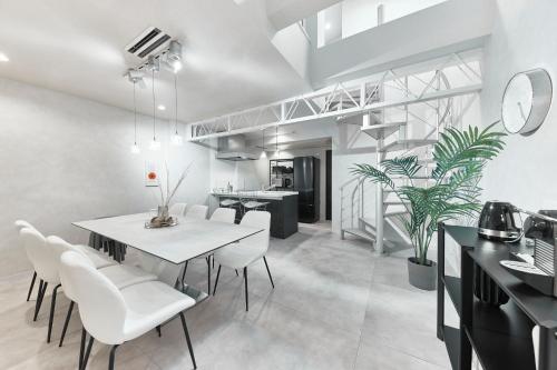 a kitchen and dining room with a table and chairs at eni suite tennoji in Osaka
