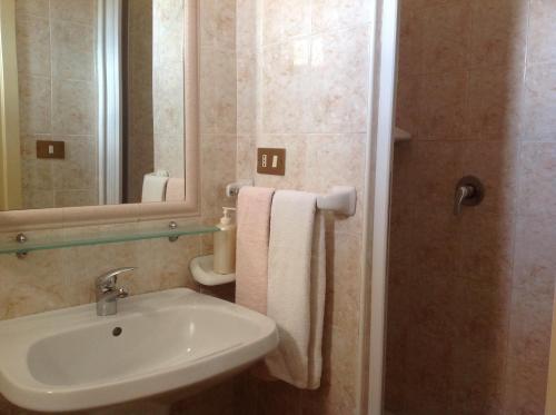 a bathroom with a sink and a mirror at Albergo Cavour in Palermo