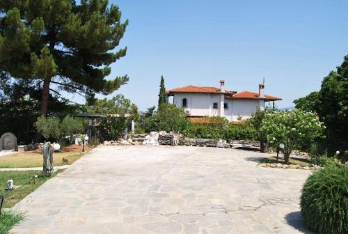 a large driveway in front of a house at Archontiko Alexandros Luxury Suites in Kardiá
