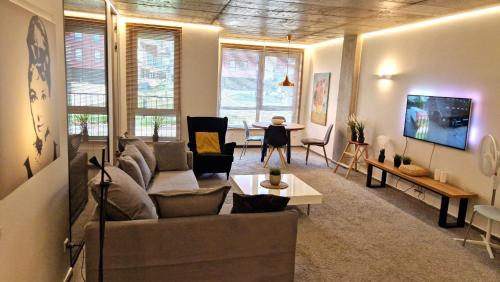 a living room with a couch and a table at Kauno-Algirdo Luxury apartments in Vilnius