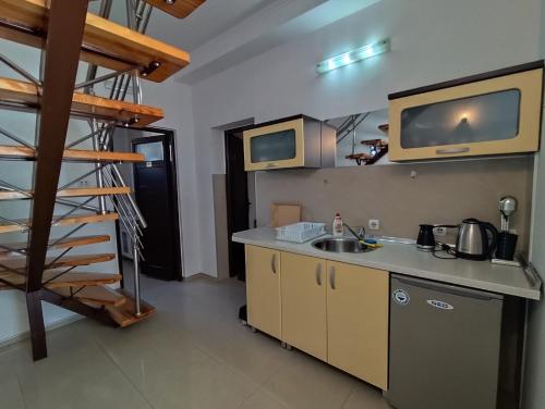 a kitchen with a sink and a counter top at Fiori Apartment in Gevgelija