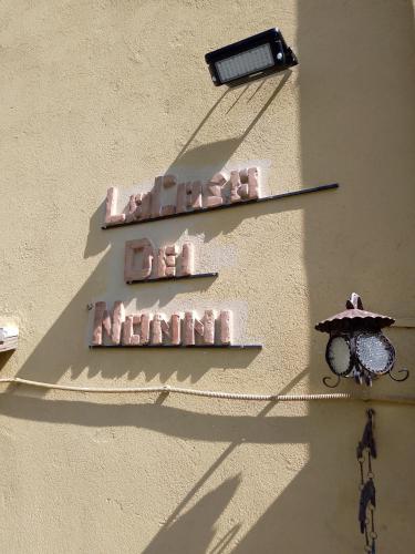 a sign on a wall with a light and a lamp at La Casa dei Nonni in Barrea