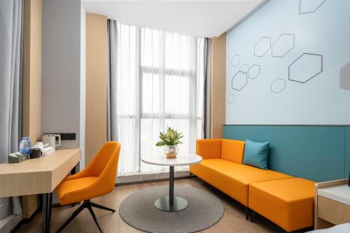 a living room with a couch and a table at Days Inn by Wyndham Zhuhai Gongbei Port in Zhuhai