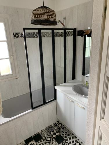 a bathroom with a shower and a sink at La Musardiere in La Baule