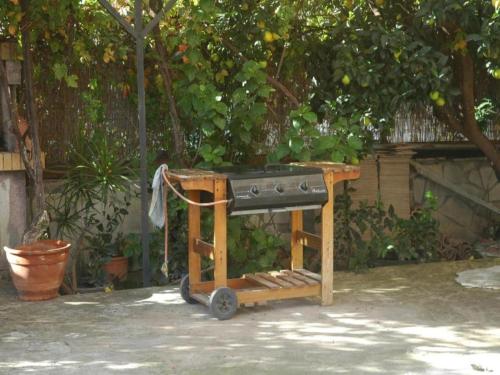 a stove sitting on a stand in a yard at Mare - Mare B in Patra