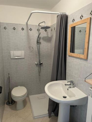 a bathroom with a sink and a toilet and a shower at Camasileo in Ortona