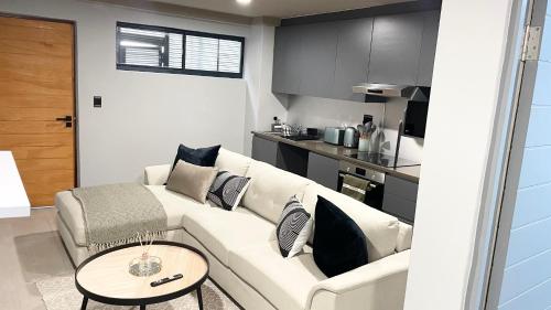 a living room with a white couch and a table at The Onyx Umhlanga in Durban