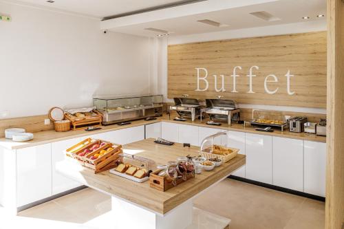 a kitchen with a buffet with bread and other food at Akritas Hotel Pefkochori in Pefkochori