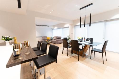 a dining room and living room with a table and chairs at Deluxe Downtown with spacious balcony in Nicosia