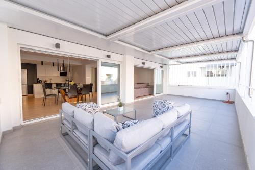 a living room with two couches and a table at Deluxe Downtown with spacious balcony in Nicosia