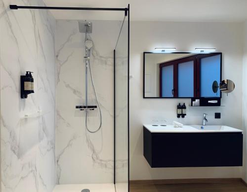 a bathroom with a shower and a sink and a mirror at Comic Art Hotel in Ghent